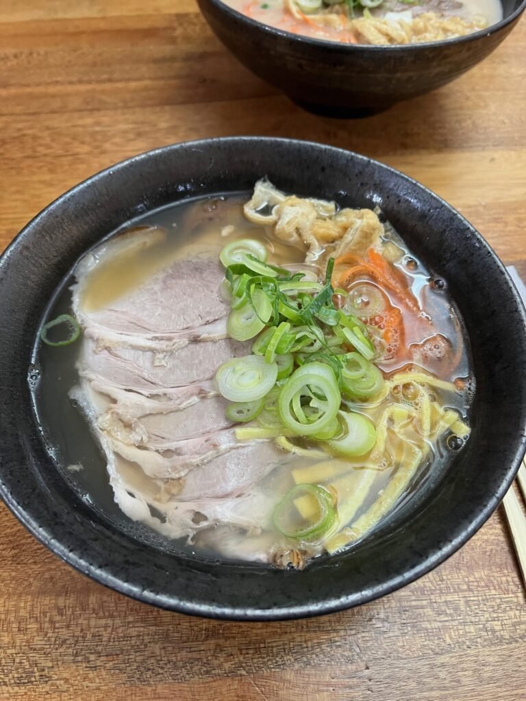Jeju gogi-guksu pork noodle soup with sliced pork, green onion, and broth